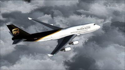 UPS Boeing 747-400F/BCF flying above clouds.