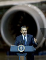 Obama in the shadow of a 787 engine.