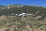 Delta Boeing 737-700  descending over the mountains