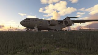 A large U.S. Air Force cargo aircraft sits on the ground at sunset, with its entry stairs extended and tall grass in the foreground.