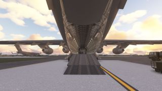 A large military cargo aircraft sits on the tarmac with its rear cargo ramp open, revealing the empty interior bay.