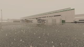 Rain falls onto a cracked airport ramp where cargo loaders and a ground vehicle are parked beside a large terminal building.