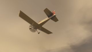 A single-engine aircraft with fixed landing gear and red tail stripes flies overhead against a hazy, golden sky.