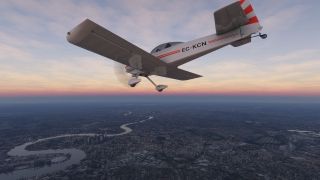 A white propeller aircraft with red stripes and fixed landing gear flies above a sprawling city and winding river beneath a pink horizon.