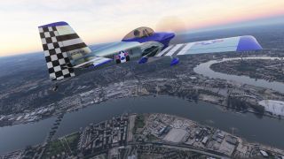 A silver and blue single-engine aircraft with a checkered tail flies above a winding river and dense urban buildings.