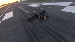A black single-engine aircraft with a checkered rudder sits on a runway covered in tire marks under a golden sky.