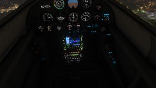 A dark cockpit features illuminated analog gauges, a color navigation display, and a transponder reading 7000, with city lights visible outside.