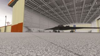 A dark flying-wing bomber sits inside an open hangar with landing gear extended, exposed roof trusses, and maintenance stairs nearby.