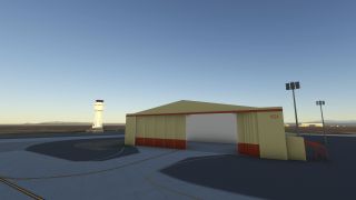 A beige hangar marked 1624 has partially open doors, with a control tower, apron floodlights, and curved yellow taxiway markings nearby.