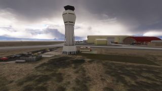 A tall airport control tower stands beside parked cars and beige hangars with a red arched canopy under heavy clouds.