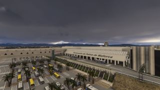 Palma de Mallorca Airport’s terminal overlooks bus parking areas lined with palm trees beneath dark clouds, with mountains in the background.