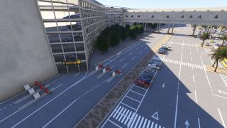 A multilevel parking garage stands beside barrier-controlled lanes, parked cars, zebra crossings, palm trees, and an enclosed overhead walkway.