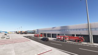 Red airport fire trucks stand outside garage bays beside an apron, with parked airliners and jet bridges in the background.