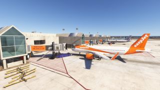 An orange-and-white easyJet airliner sits beside a terminal jet bridge, with a purple pushback tug and yellow tow bars nearby.