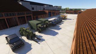 Canvas-covered trucks, dark utility vehicles, a green forklift, and a yellow maintenance platform stand in a concrete courtyard between brick buildings.