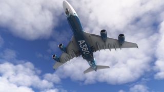 A blue-and-white Airbus A380 flies overhead with landing gear extended, four engines and large underside lettering visible against scattered clouds.