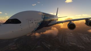 An Airbus A380 in FlyByWire livery flies above an airport, with two engines visible beneath its wing and golden clouds behind.