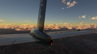 A rear view shows an airliner’s tail and horizontal stabilizers above urban terrain, with golden clouds along the horizon.