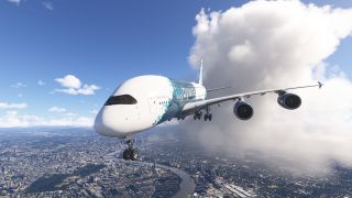 An Airbus A380 in blue and white livery flies with landing gear extended above a winding urban river beside large clouds.
