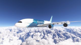 A double-deck airliner with blue and white FlyByWire livery flies above dense clouds, with two engines visible beneath its near wing.