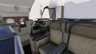 The aircraft cabin features quilted beige seats, tall privacy partitions, woodgrain side consoles, and oval windows.