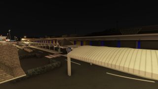 An airport terminal stands beside illuminated access roads at night, with covered walkways, pedestrian crossings, and blue facade columns.