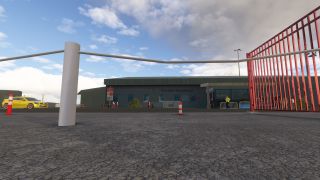 A low airport terminal stands behind white railings and red bollards, with a yellow car and pedestrians near the entrance.