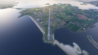 A coastal airport occupies a narrow peninsula, with a marked runway, intersecting taxiways, nearby fields, and sandy shorelines surrounded by water.