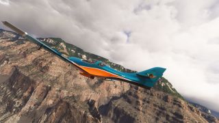 A teal and orange aircraft banks beside steep rocky cliffs topped with trees beneath thick gray clouds.