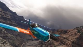 A turquoise and orange propeller aircraft banks through a rocky canyon beneath thick gray clouds, with two occupants visible under its canopy.