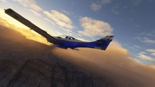 A blue and white light aircraft banks above rugged canyon terrain, with golden clouds surrounding its black-and-white patterned tail.