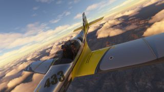 A yellow and silver aircraft marked 433 banks above rugged canyons and sunlit clouds, with two occupants visible beneath its canopy.