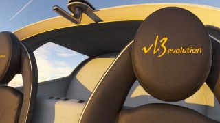 Two black cockpit seats feature yellow VL3 evolution embroidery beneath a yellow canopy frame with an overhead latch.