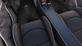 Two dark upholstered cockpit seats flank a center console with throttle and trim levers, while dual control sticks rise from the floor.