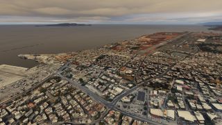 A coastal airport runway borders dense urban blocks and a harbor, with an offshore island visible beneath overcast skies.