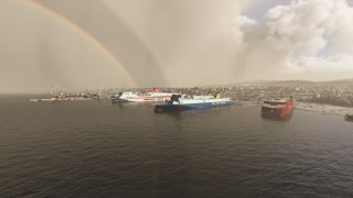 Three large ferries sit in a harbor beside cranes and hillside buildings, while a rainbow arcs across the cloudy sky.