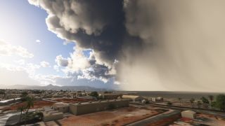 Dark storm clouds and a dense rain curtain loom over a coastal town with low buildings, palm trees, and distant mountains.