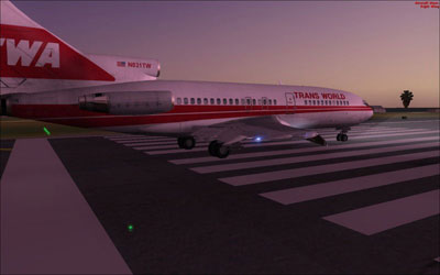 TWA 727 on runway at dusk