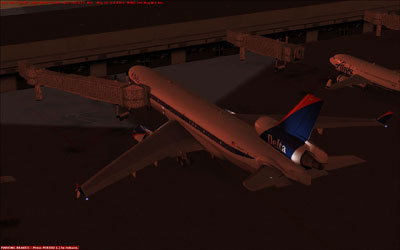 Delta MD-11 docked at gate at night