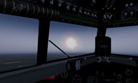 View from the cockpit of a plane flying towards the afternoon sun.