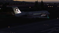 Screenshot of Horizon Air CRJ-200 landing on runway at night.