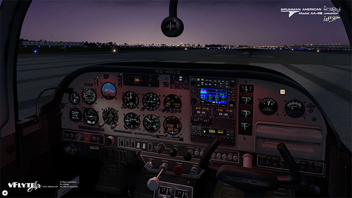 3D virtual cockpit with night lighting at dusk.