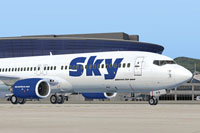 Screenshot of a blue Sky Airlines Boeing 737-800 on the ground.