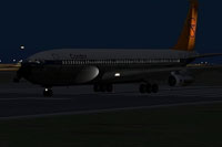 Screenshot of Boeing 707-300 on runway at night.