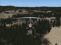 Glider flying over scenery with enhanced forest textures.