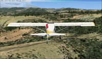 Screenshot of plane flying over St Rome de Tarn scenery.