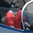 Pilot with sunglasses and a red Ferrari t-shirt.
