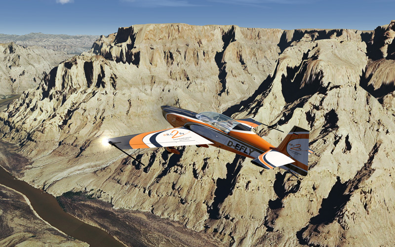 Light aircraft flying over terrain.