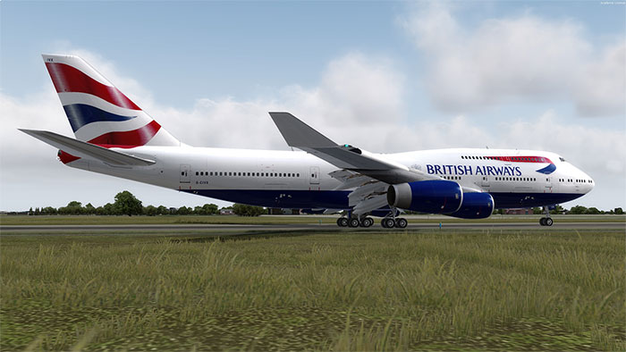 British Airways 747 on runway with clouds in distance and grass in foreground.