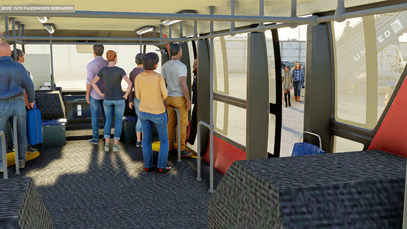 Passengers arriving at aircraft on bus from terminal.
